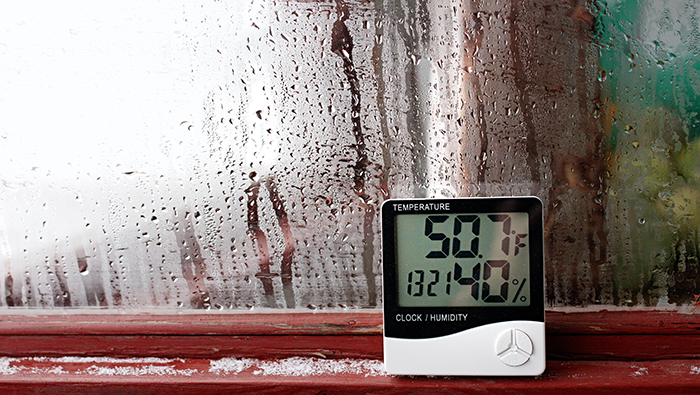 hygrometer placed next to a condensated window